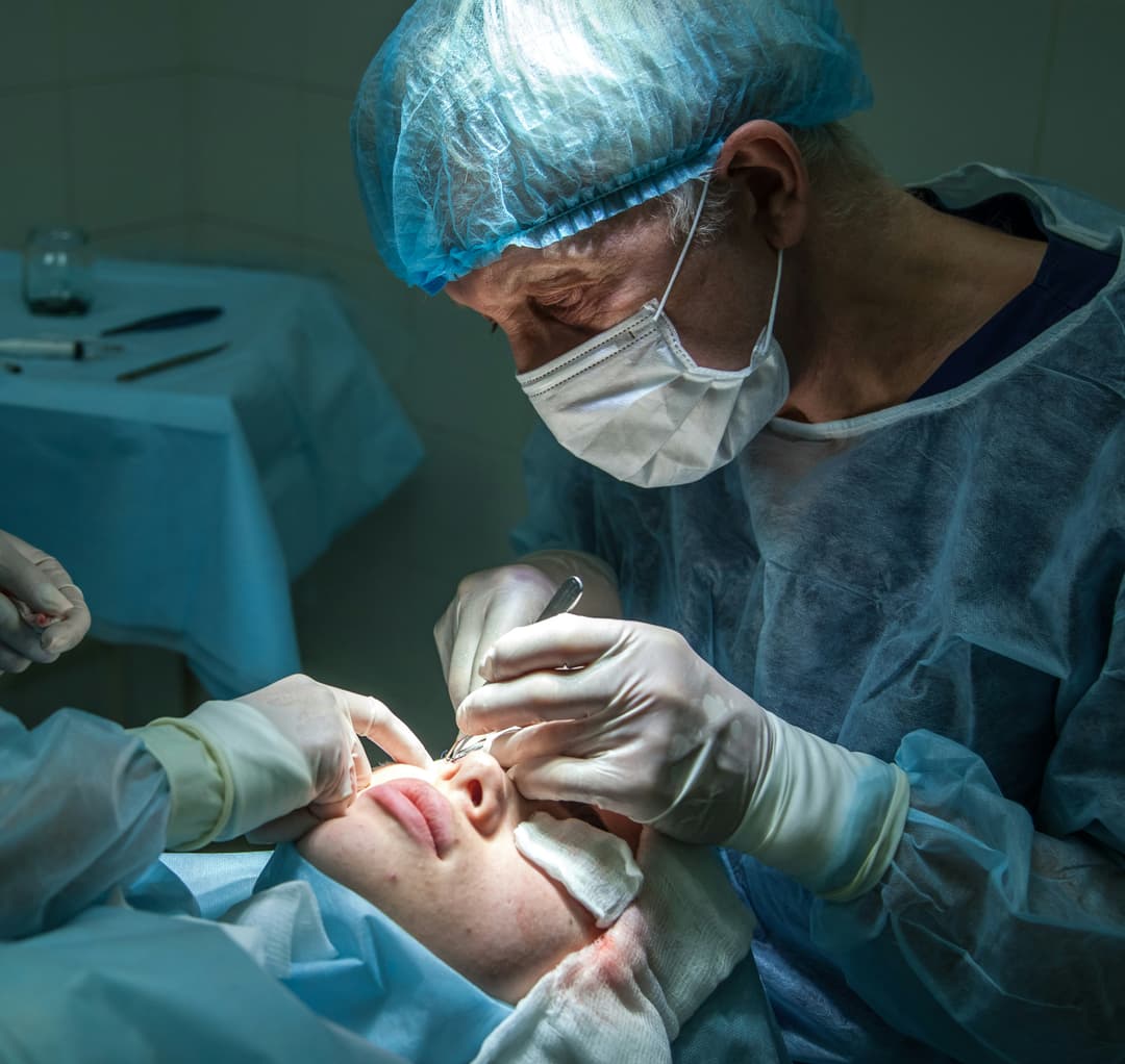 Surgeon performing a medical procedure on a patient overseas, representing medical tourism and international treatment options.