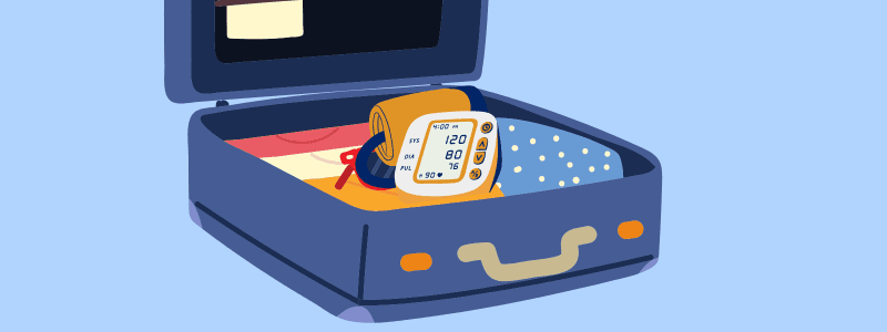 Open suitcase with clothes and a digital blood pressure monitor (120/80) and cuff.