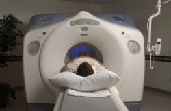 A person in hospital lying on an MRI table A person in hospital lying on an MRI table