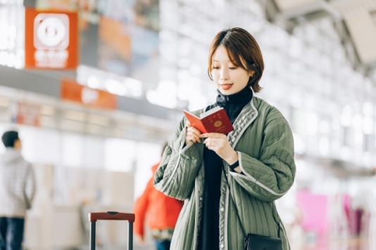 A Japanese looking at her passport