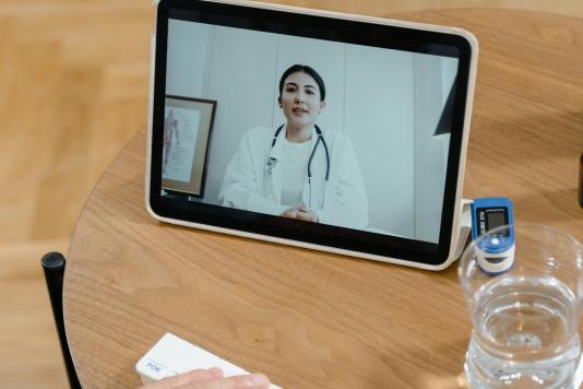 A doctor speaking to a patient using a telehealth service